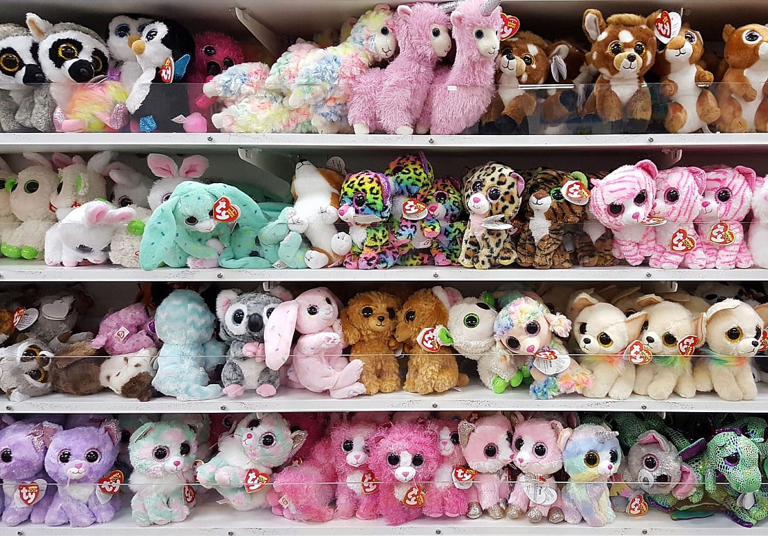 Beanie Babies displayed on shelves in a shop.