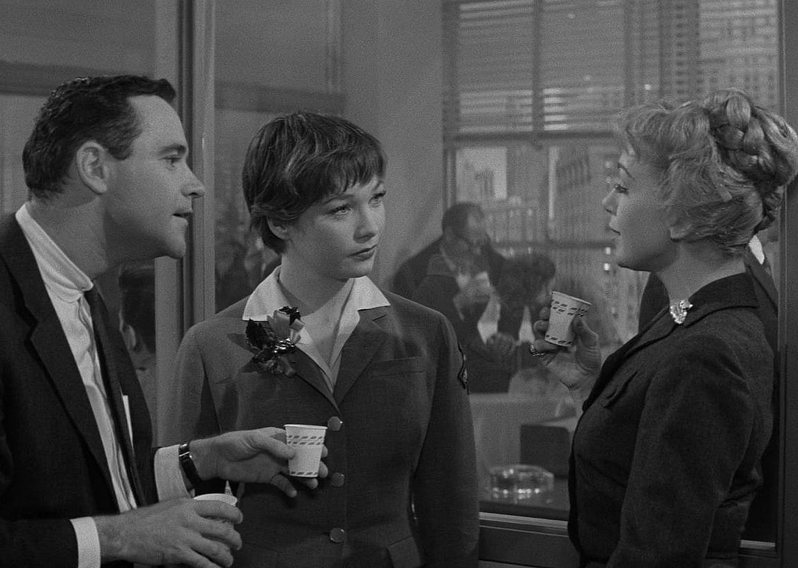 Jack Lemmon and Shirley MacLaine at an office party.
