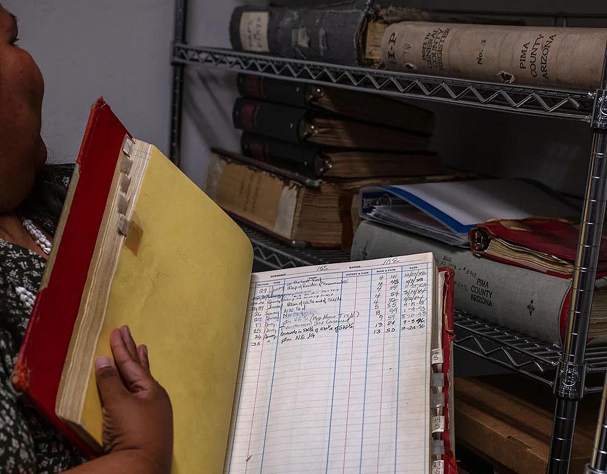 Gabriella Cázares-Kelly goes through old Pima County records at her offices in Tucson, Arizona.