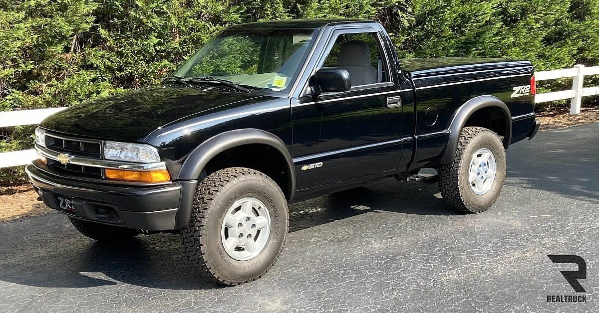 A black Chevy S10 parked on roadside.