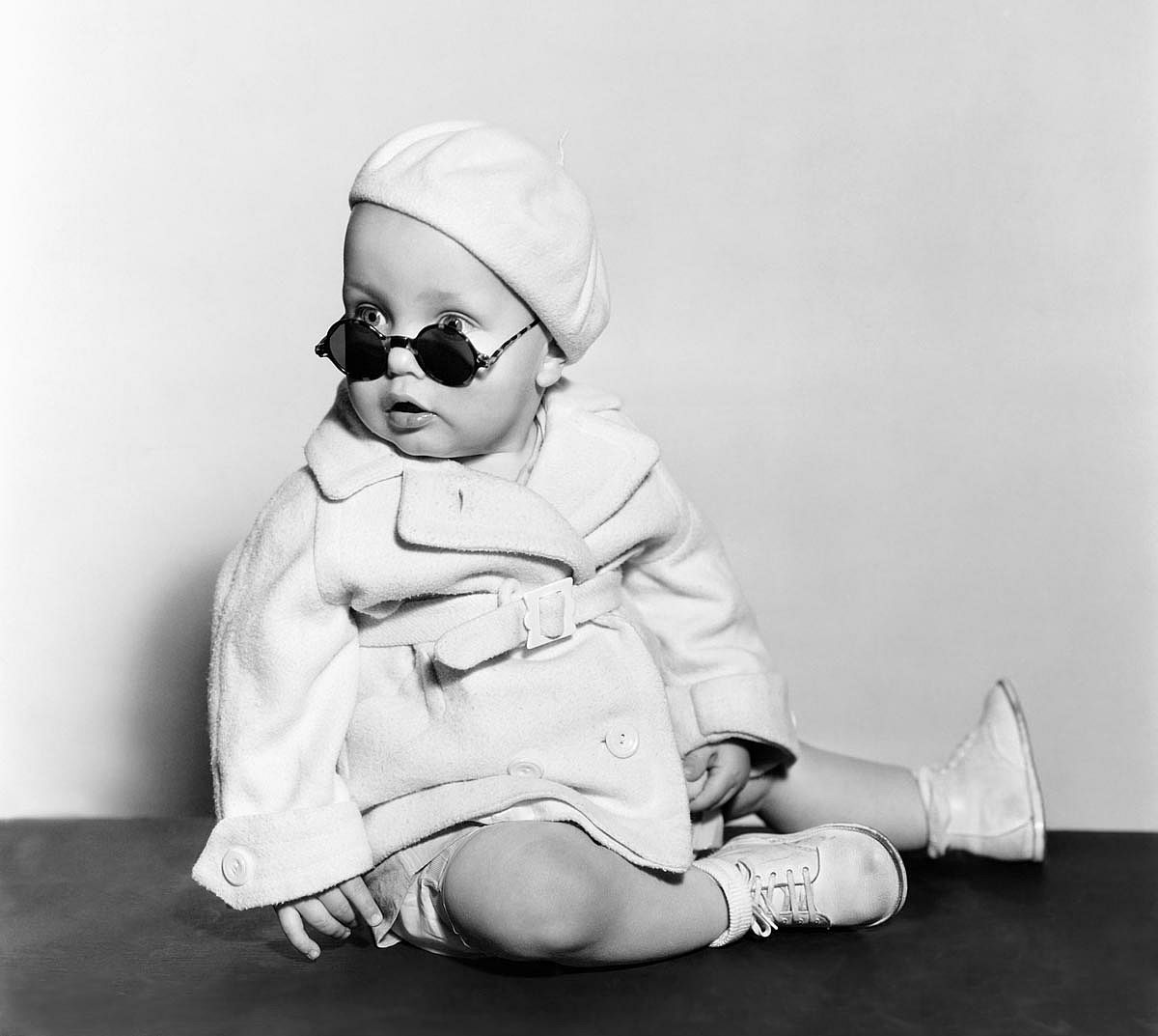 1940s baby wearing a beret and sunglasses