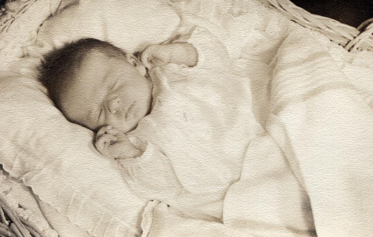 Black and white photo of a baby in the 1940s sleeping