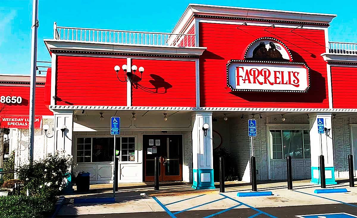 Exterior of a Farrell's Ice Cream Parlour restaurant with its distinctive bright red facade and marquee sign above the entrance.