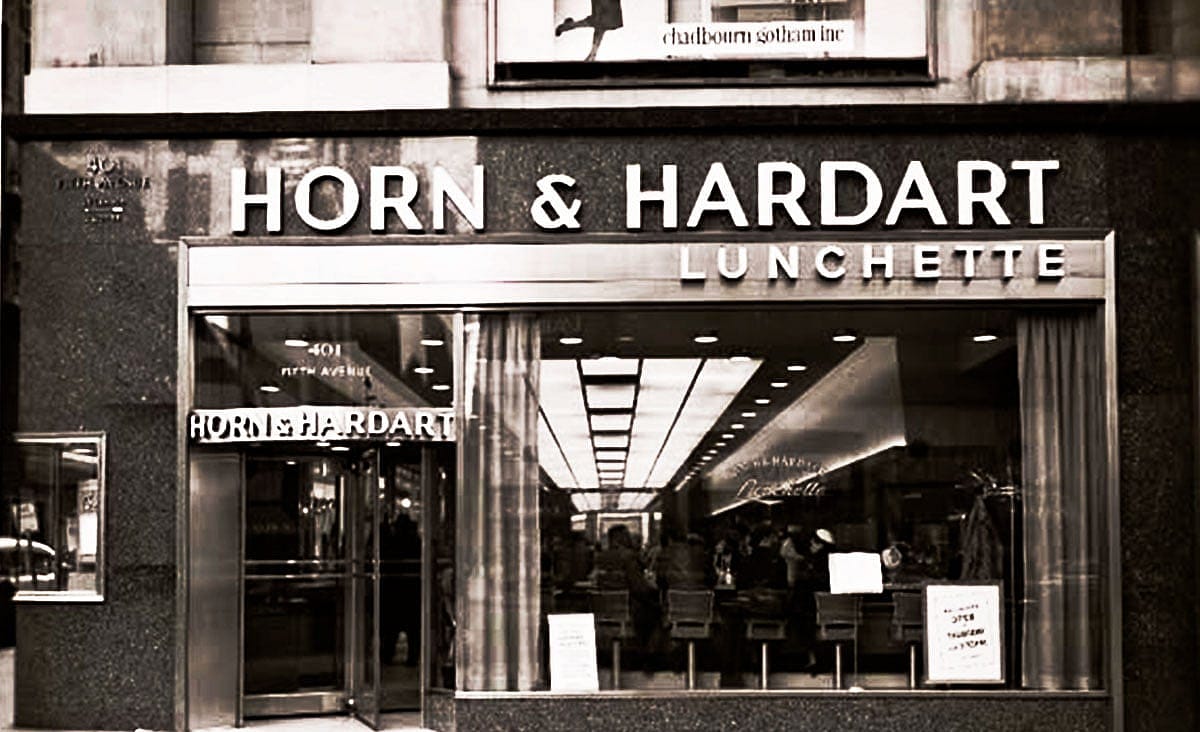 Historic Horn & Hardart Lunchette storefront with large signage above the entrance and customers visible inside the restaurant.