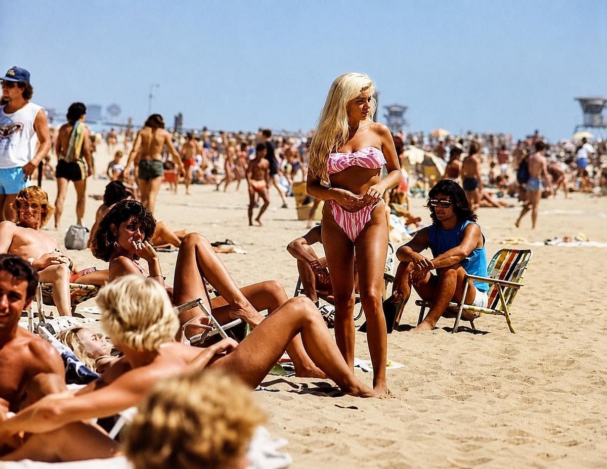 Woman and group of people at the beach in California