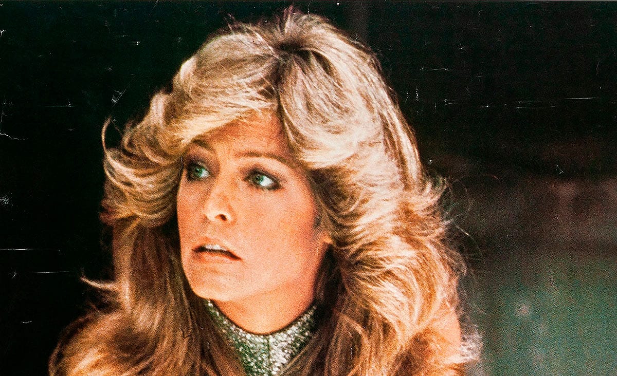 Farrah Fawcett in Logan's Run (1976), looking off to the side with a concerned expression while wearing a shimmering high-collared outfit.