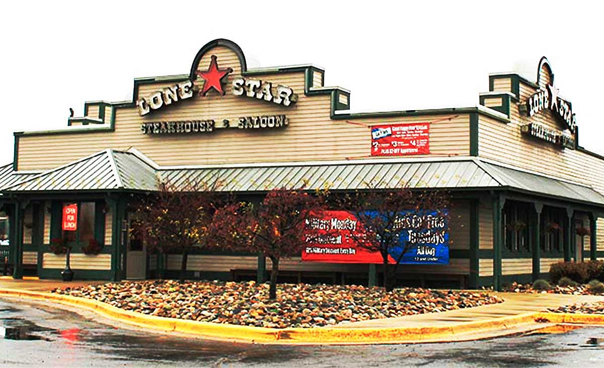 Exterior of a Lone Star Steakhouse & Saloon restaurant with Western-style architecture and the restaurant's star logo above the entrance.