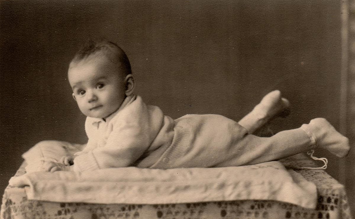 Black and white portrait of a baby in the 1940s with pajamas on