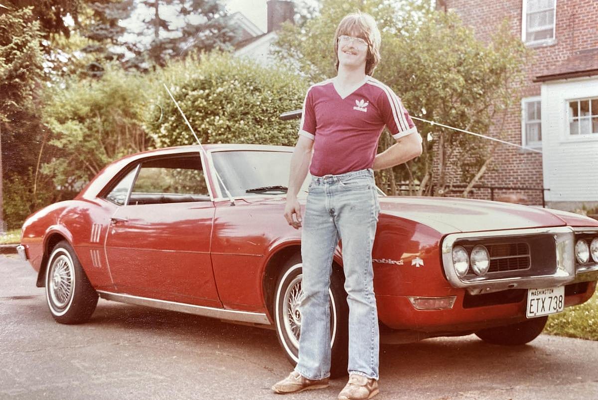 Proud man next to his car in 1984