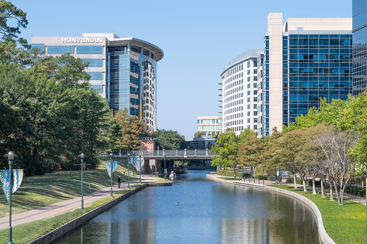 A river winding its way through the business district of an urban community.
