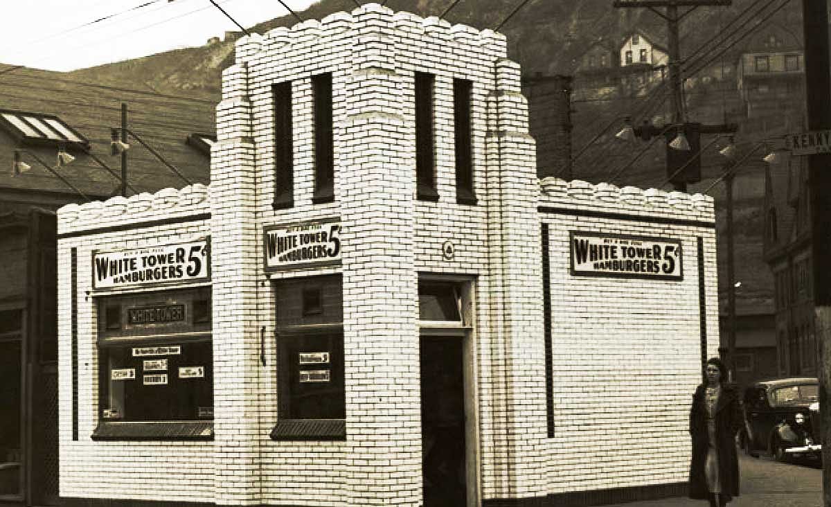 Historic White Tower hamburger restaurant with a white brick Art Deco exterior and signs advertising 5-cent hamburgers.