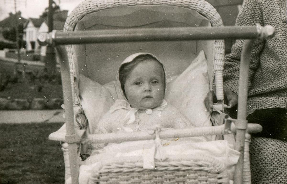 Vintage photo of baby girl in a stroller.