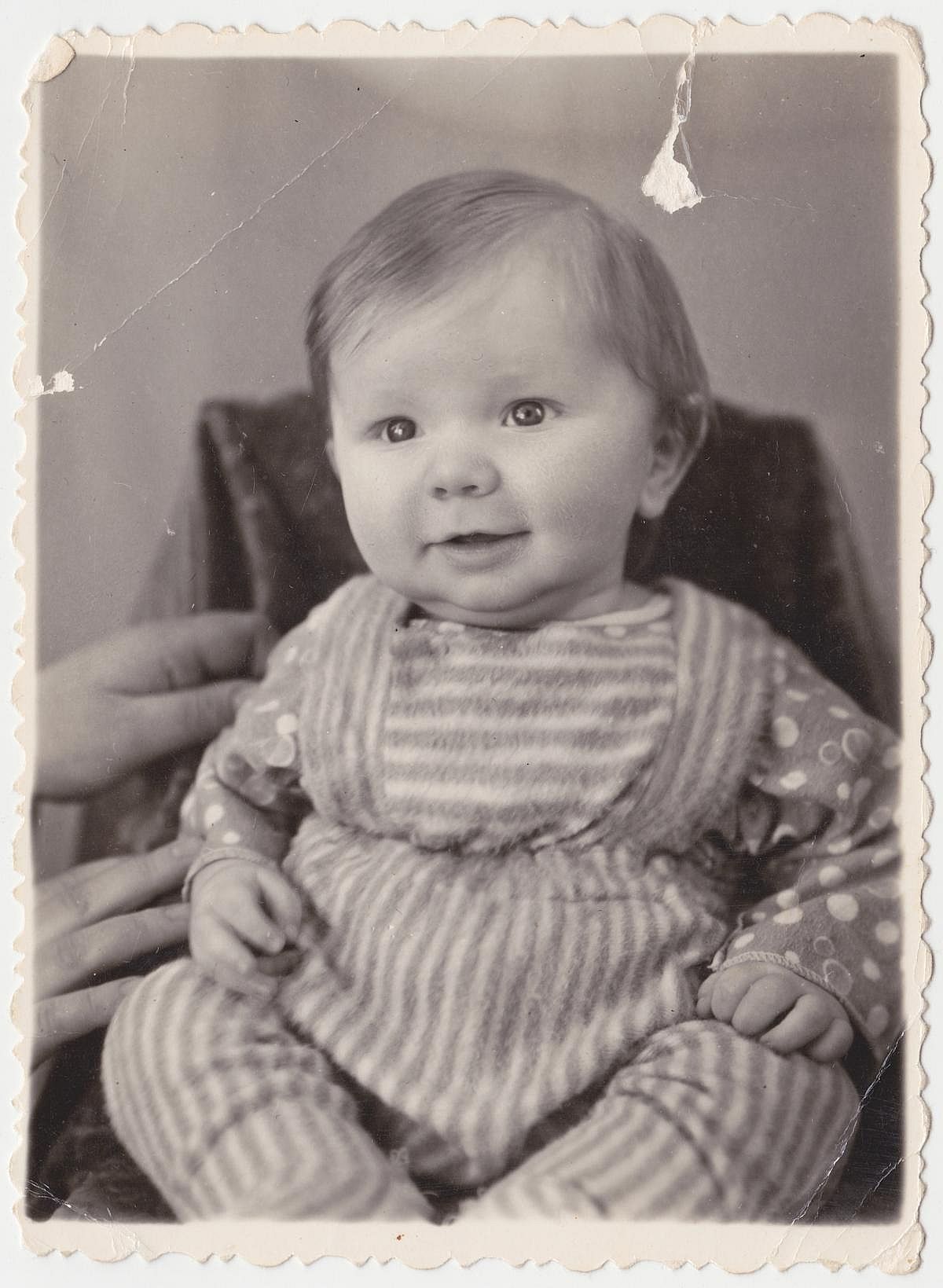 An interesting old photograph of a sweetheart who recently learned to sit. The photo has a pleasant vintage charm. 