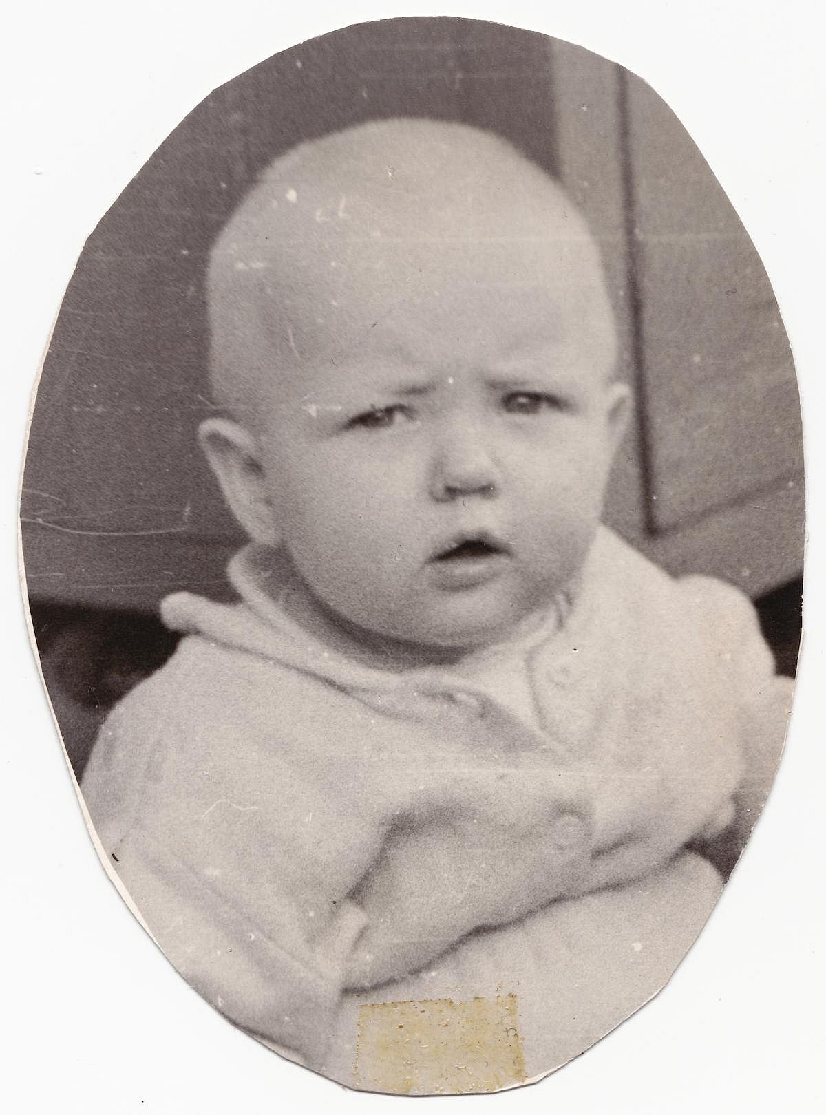 An interesting old photograph depicting a portrait of a cute baby in an oval