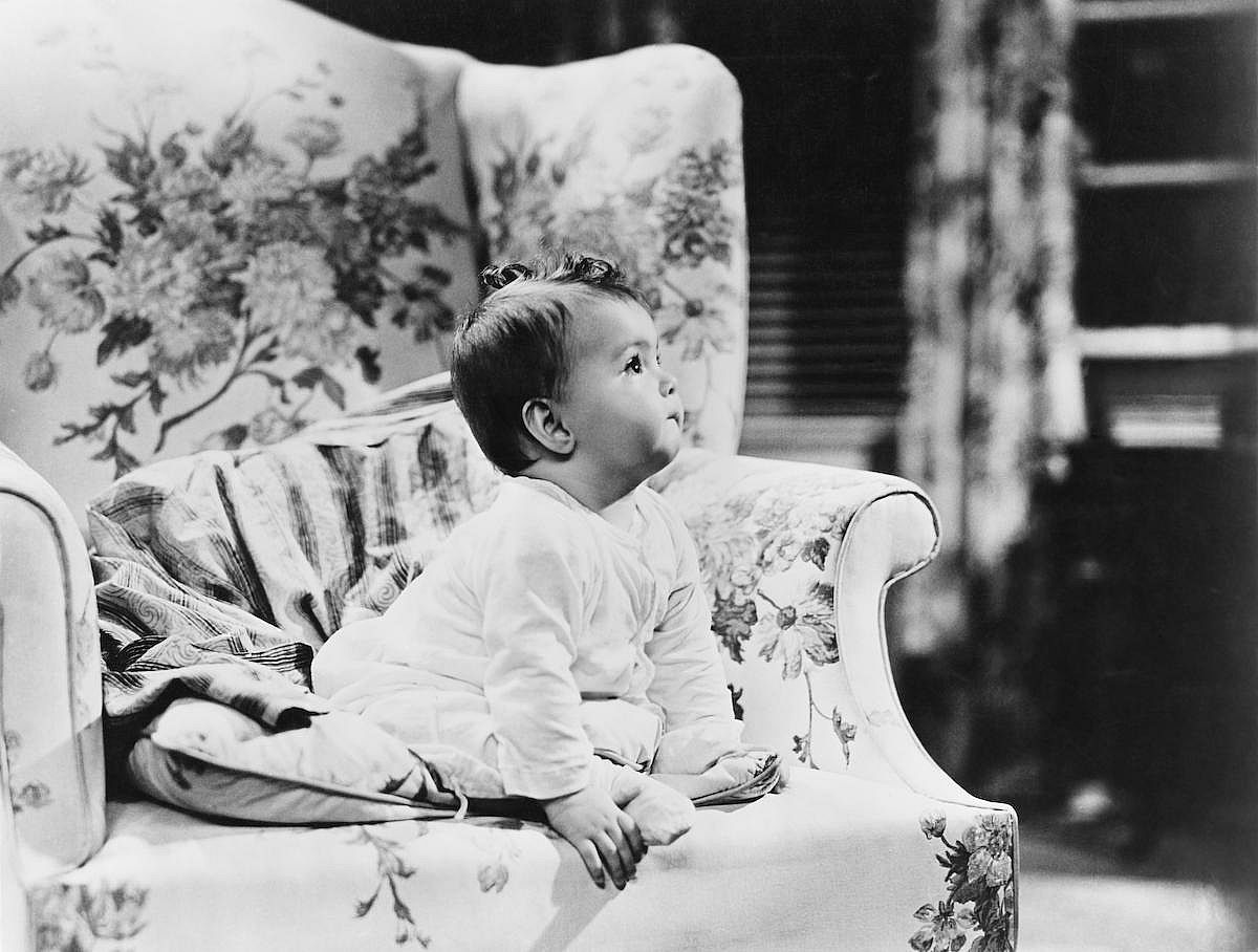 Baby sitting on armchair
