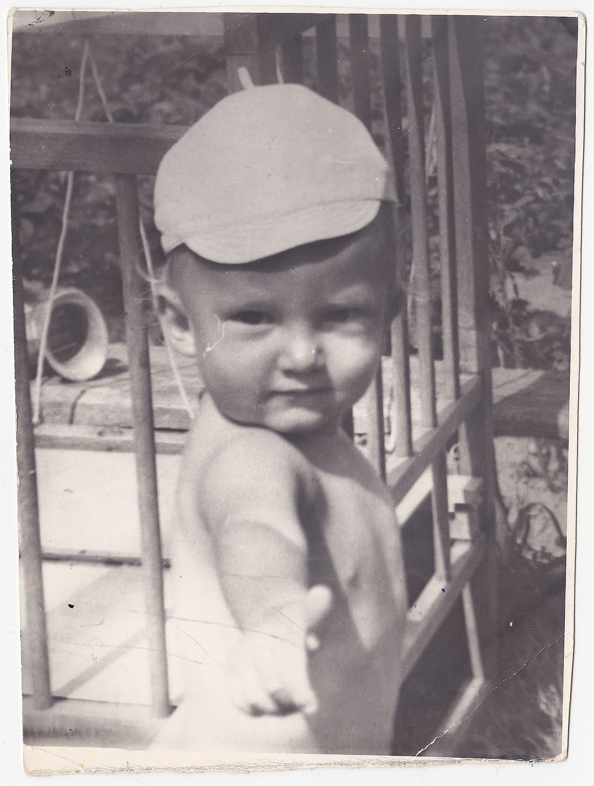 Vintage photo of baby boy wearing a hat in the 1960s.