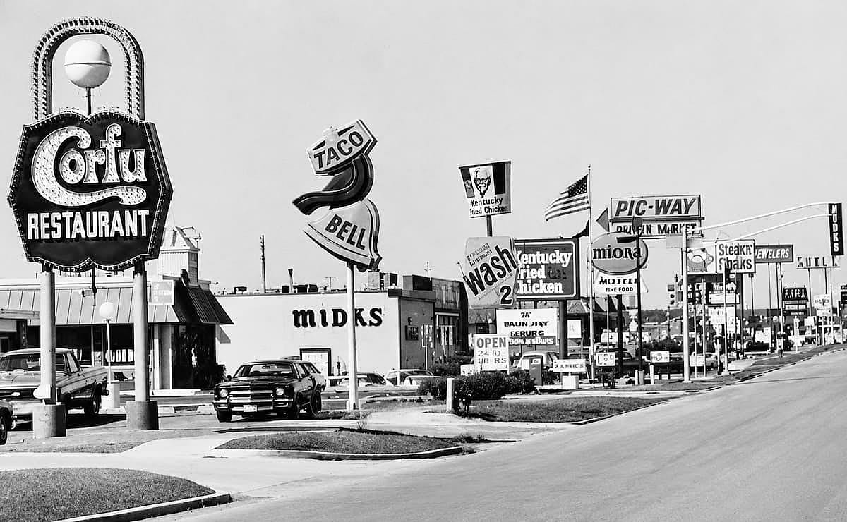 A commercial street full of stores and restaurants in Chicago, 1980.