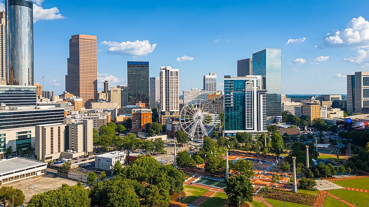 Aerial view of Atlanta downtown skyline with towers, parkland and bright cityscape; ideal for FIFA 2026 World Cup travel, tourism, real estate and business branding uses