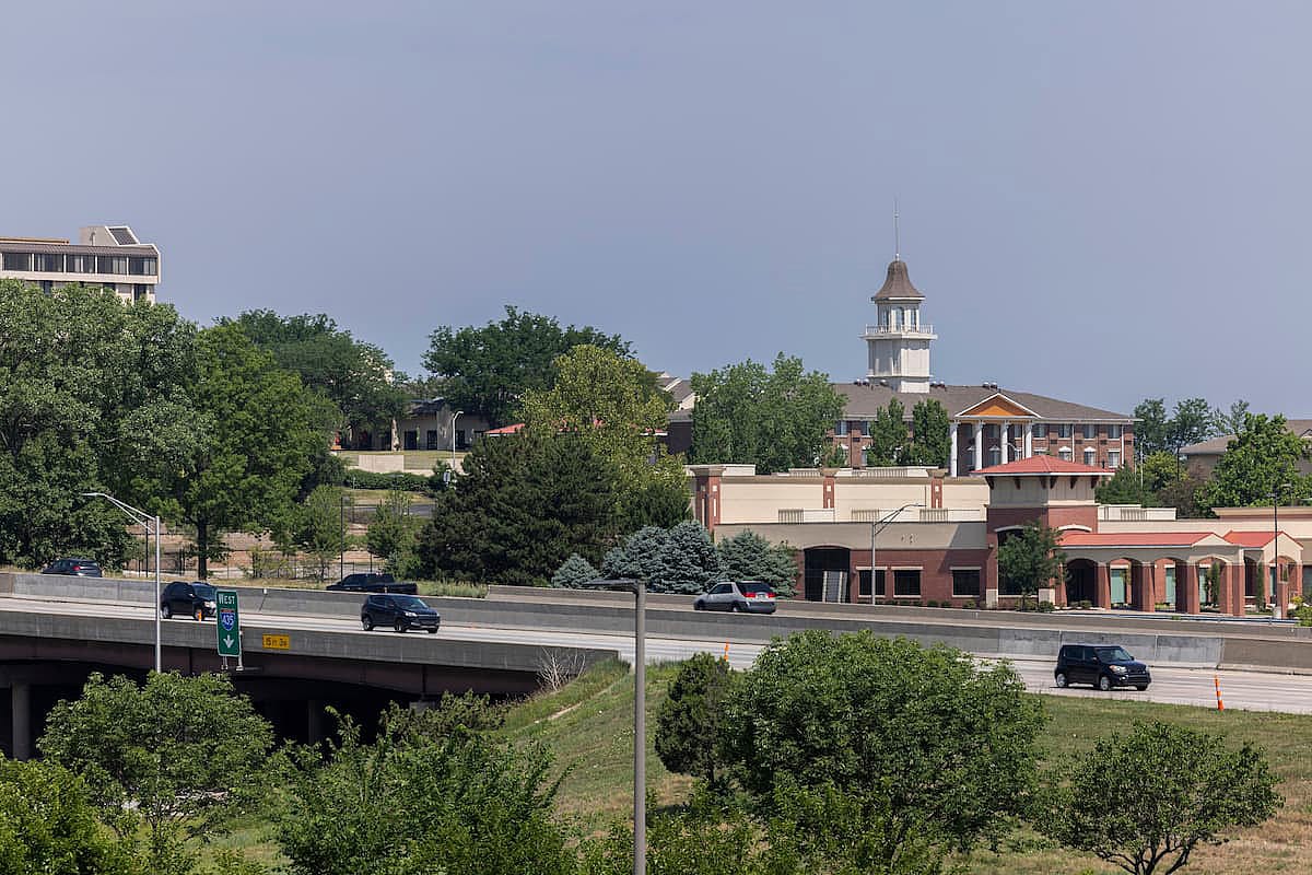 Morning traffic passes through the downtown commercial district of Overland Park.