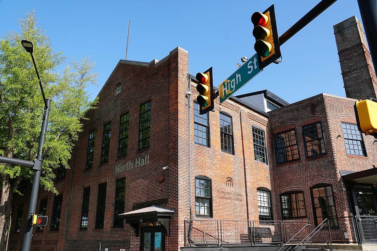 The North Hall building at Montgomery County Community College with brick exterior, windows, and High Street intersection signage.