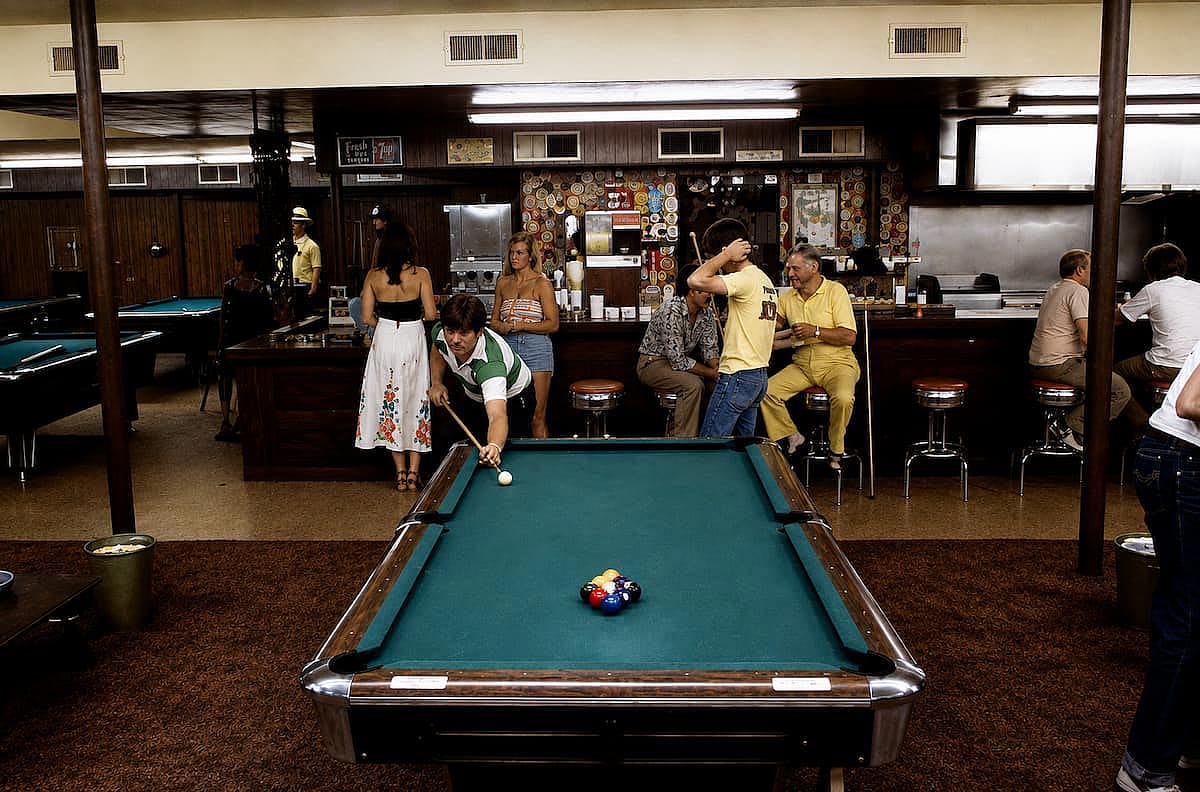 A group of friends enjoying time together at the pool hall, in 1980.