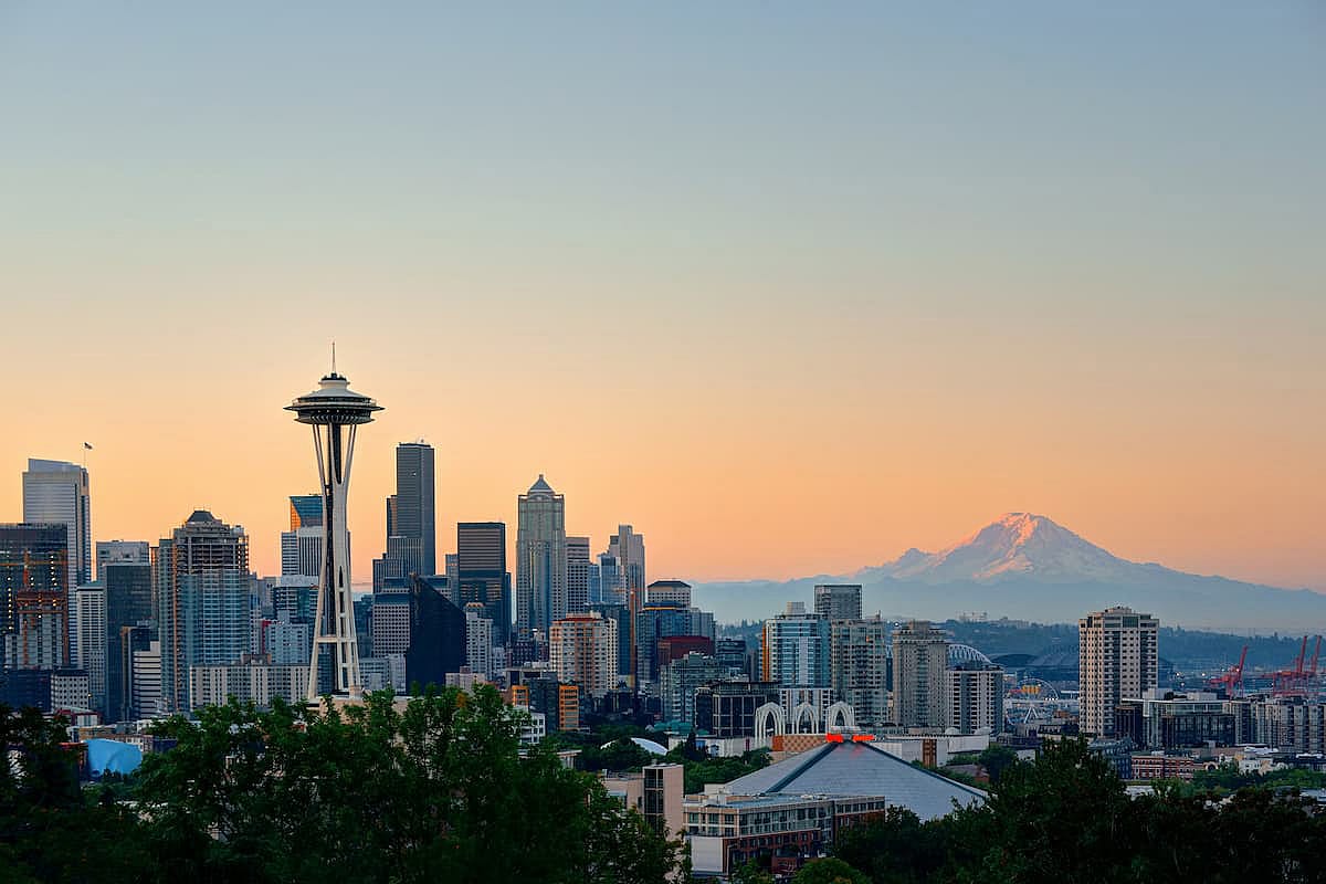 Seattle city skyline with Mt Rainier at sunset with urban office buildings viewed from Kerry Park.