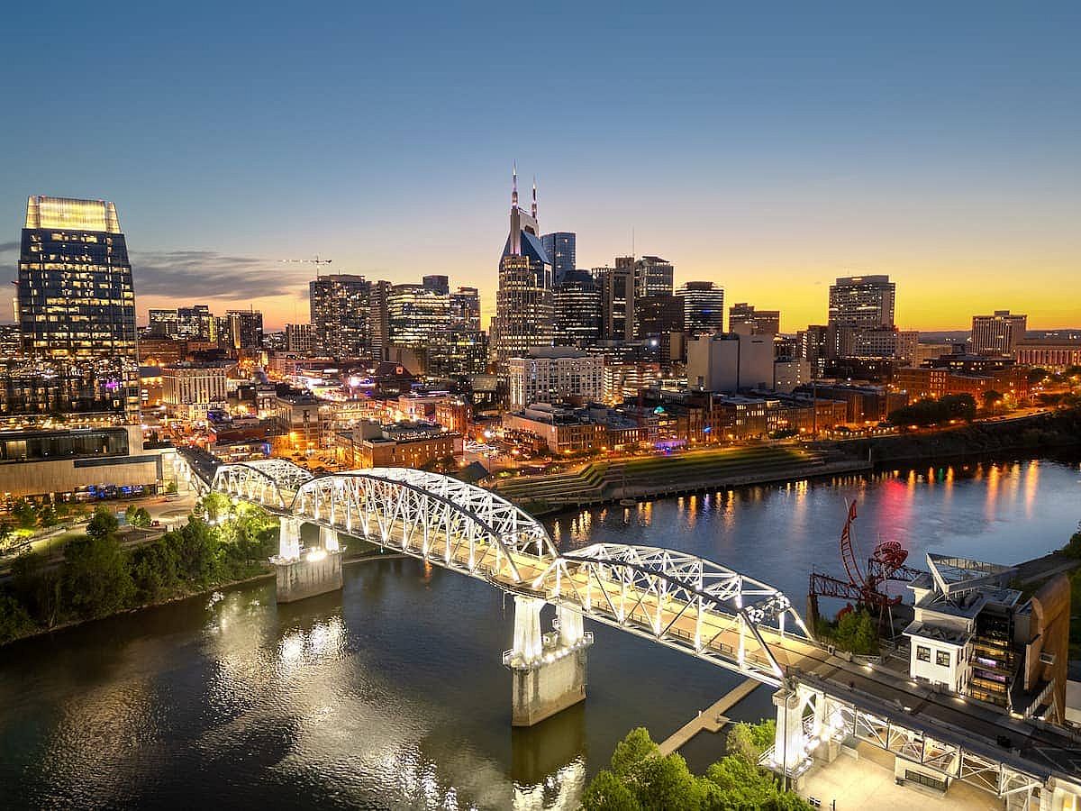 Nashville, Tennessee, USA skyline over the Cumberland River at golden hour.