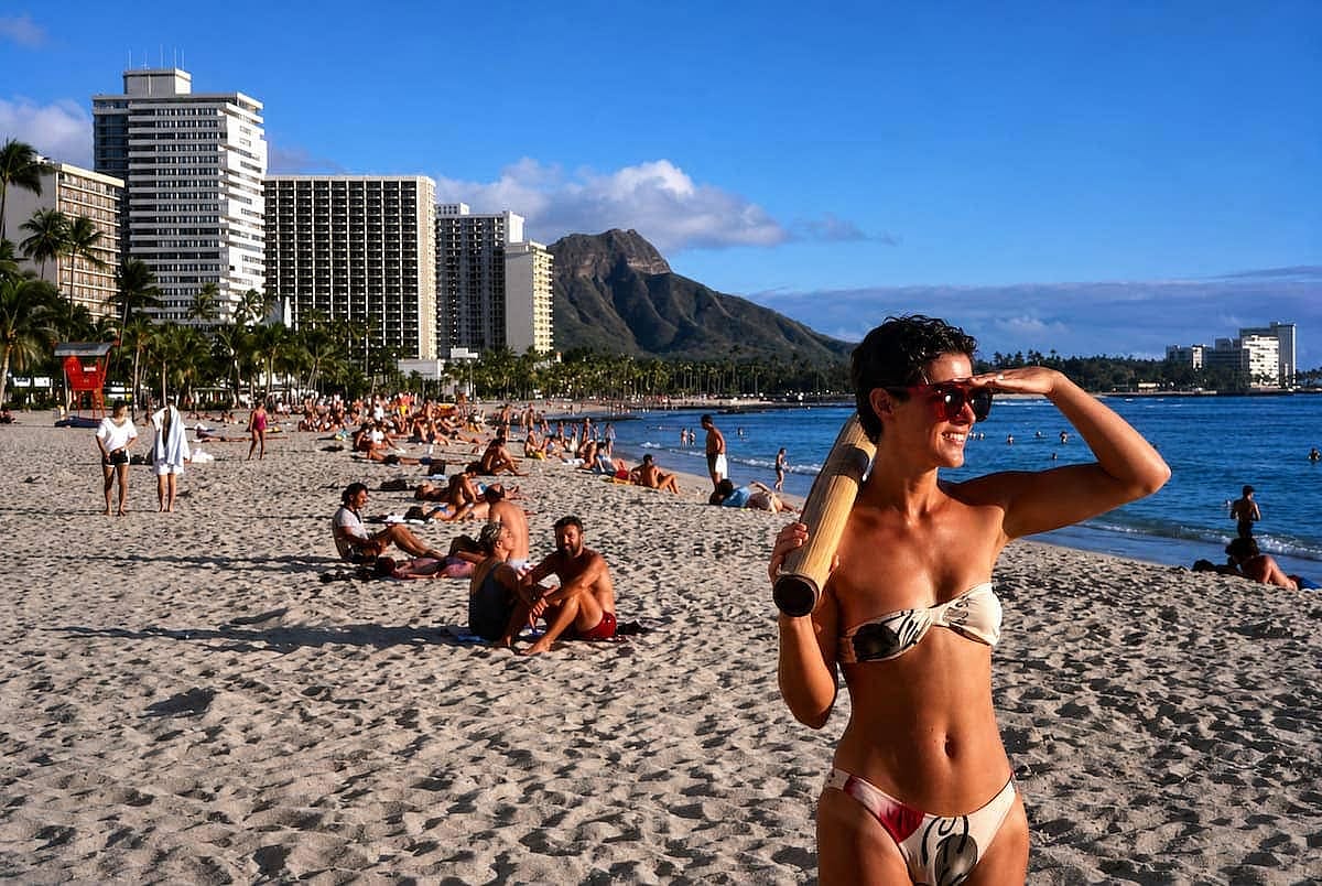 Woman in a bikini enjoying a day in Waikiki beach, during the summer of 1980.