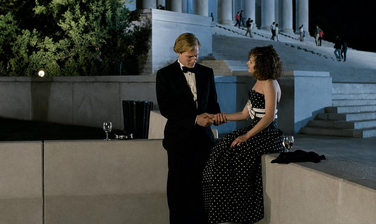 Holly Hunter and William Hurt dressed up outdoors for a scene of Broadcast News.