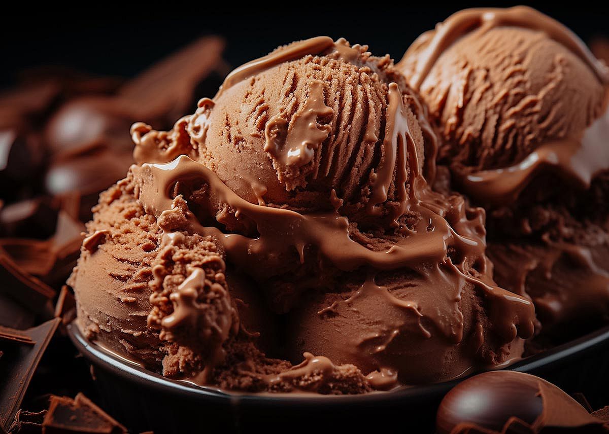 Scoop of brownie ice cream in a black bowl.