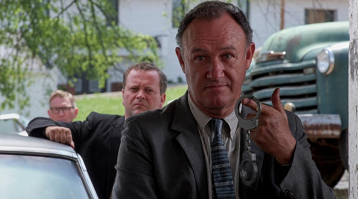 Gene Hackman holding handcuffs for a scene in Mississippi Burning (1988)