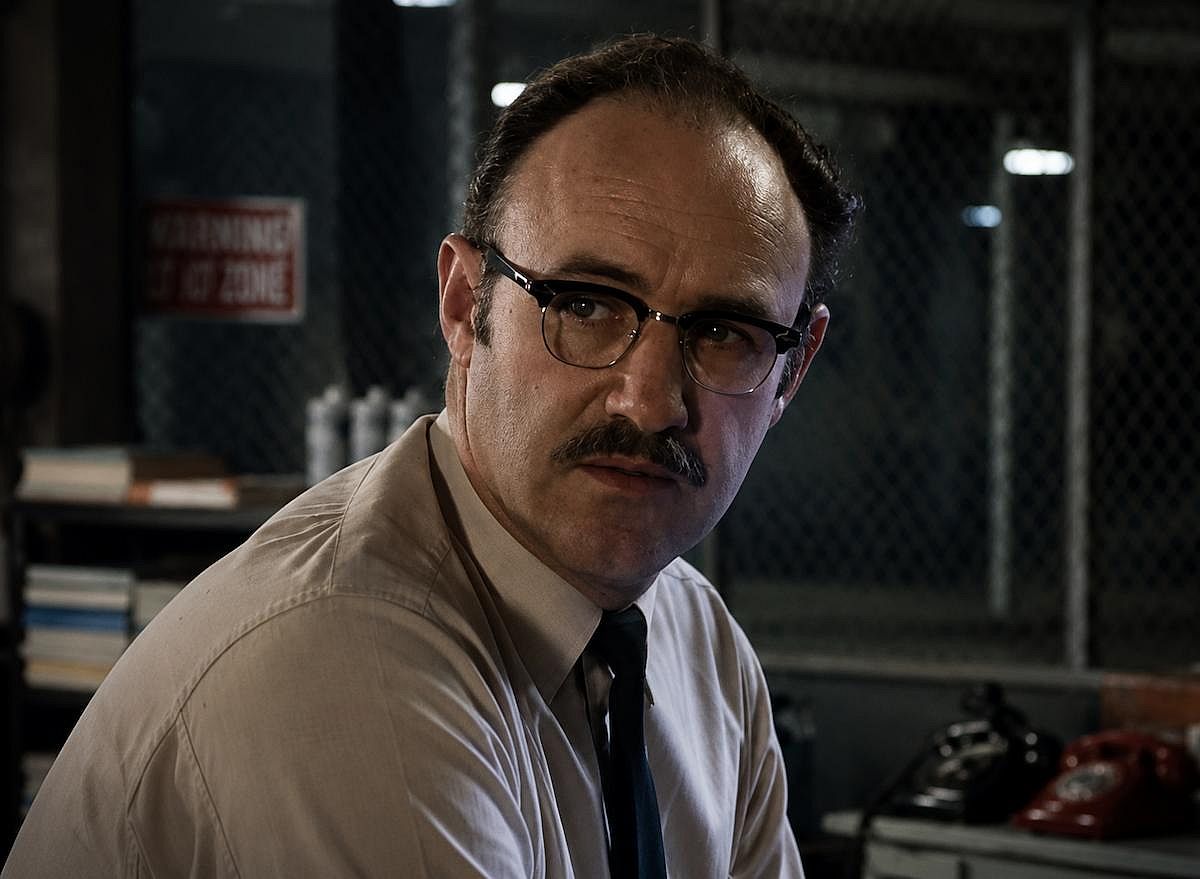 Gene Hackman wearing a suit and glasses while filming a scene for The Conversation (1974)
