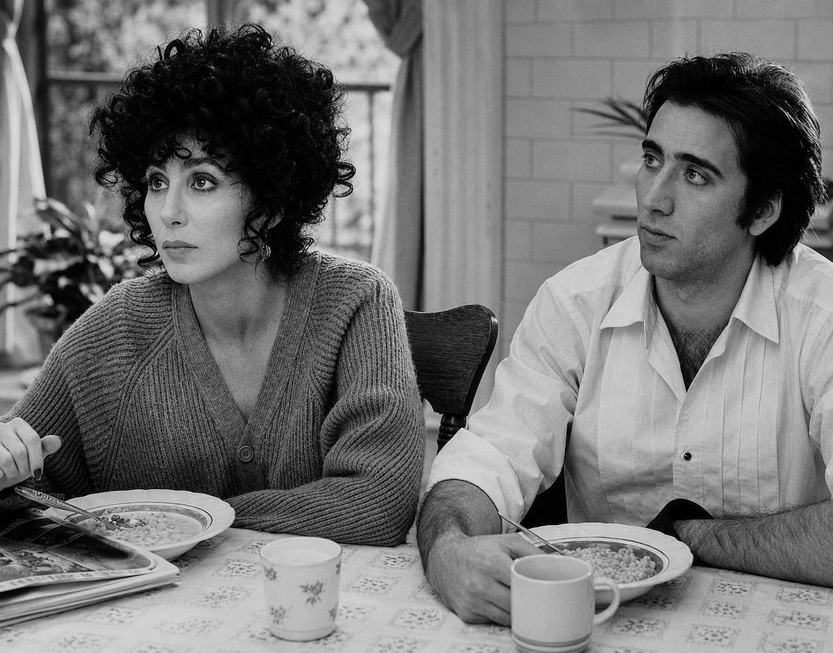 Nicholas Cage and Cher looking to the side in a scene of Moonstruck (1987)