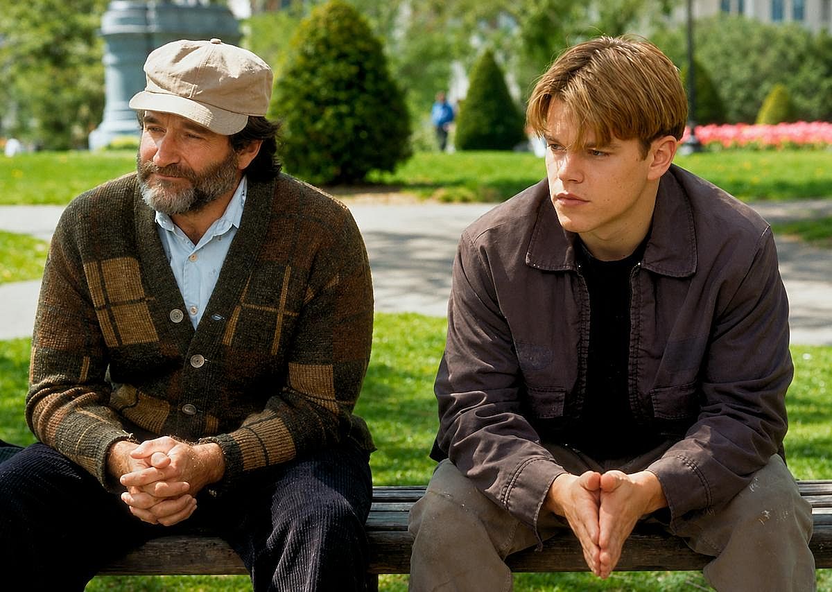 Robin Williams sitting at a bench on a park during a scene of Good Will Hunting (1997)