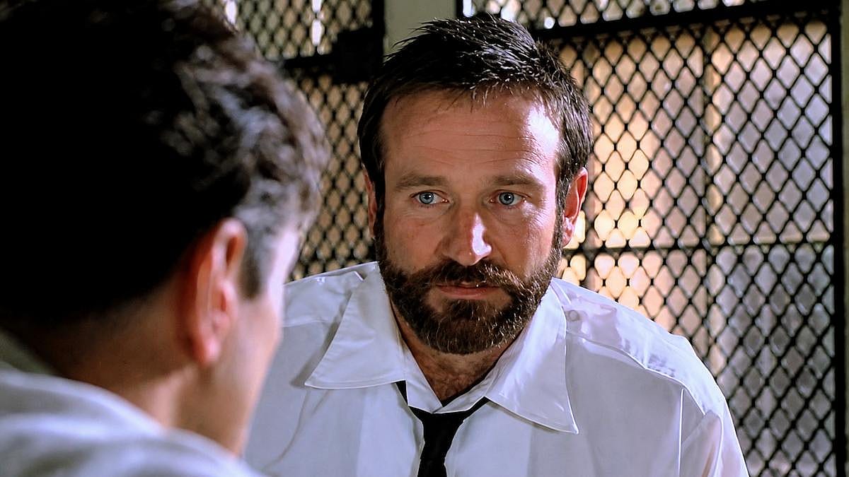 Robin Williams wearing a suite and looking in the eye in Awakenings (1990)