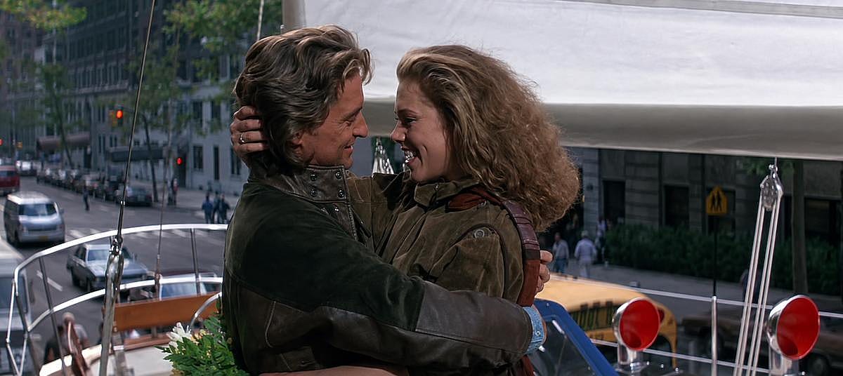 Michael Douglas and Kathleen Turner hugging for a scene of Romancing the Stone (1984)