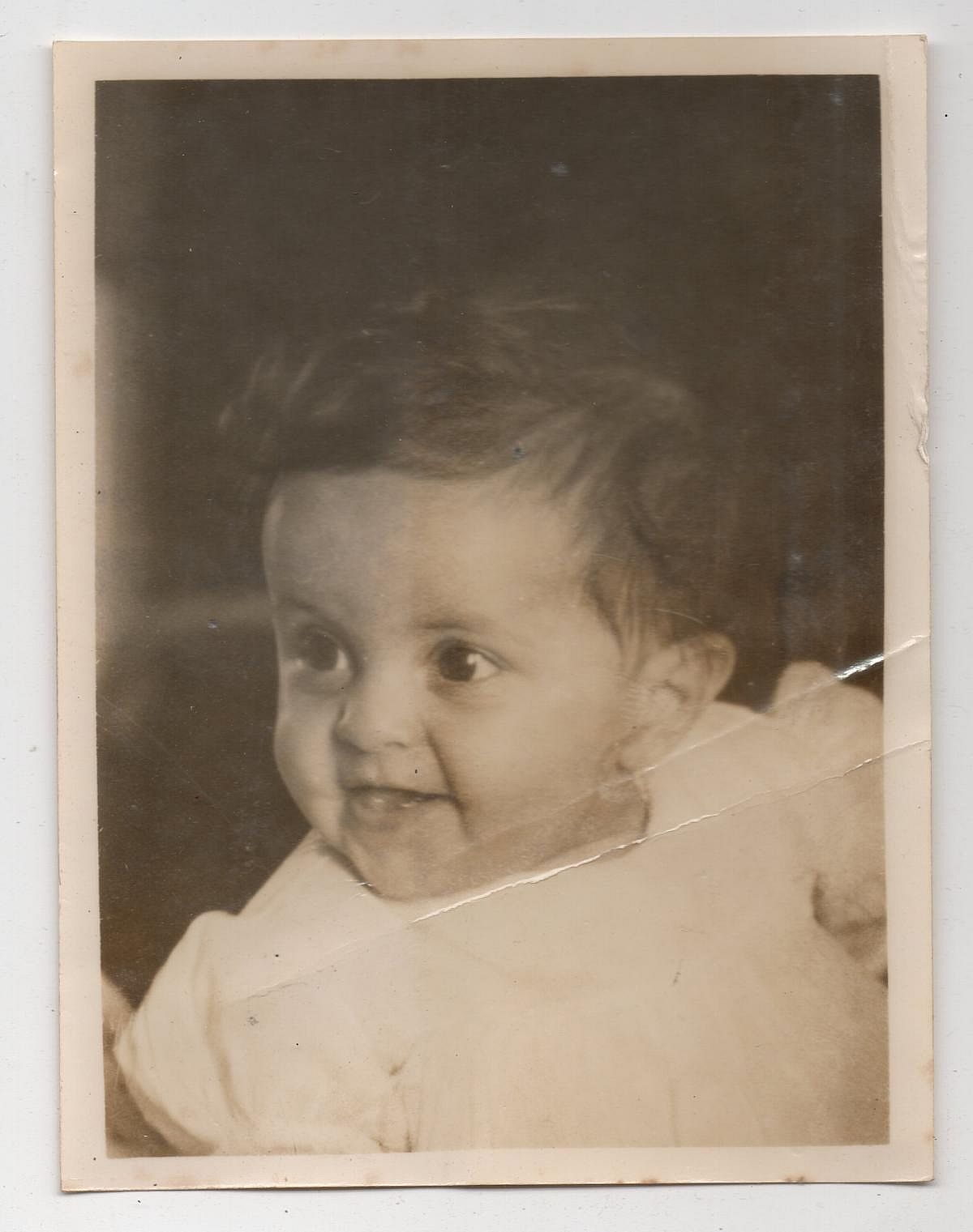 Baby girl smiling for a photo in 1940.