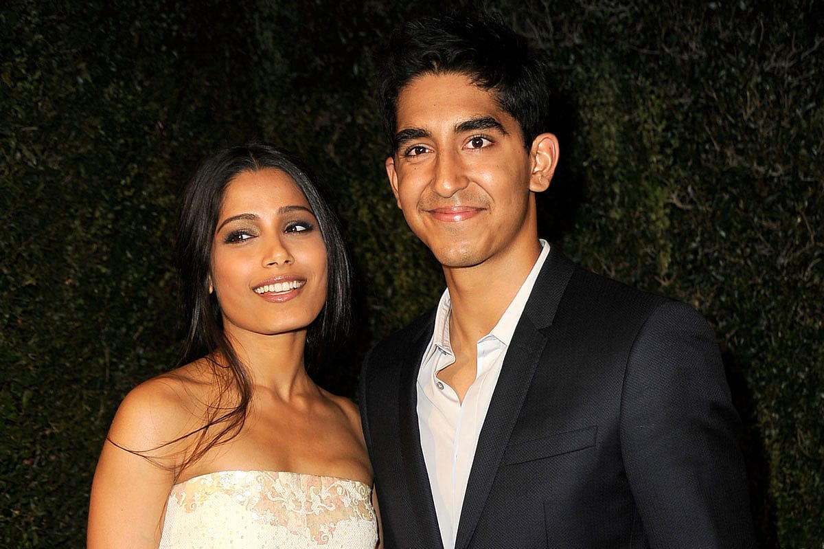 Actors Freida Pinto and Dev Patel arrive at the Chanel And Charles Finch Pre-Oscar Dinner at Madeo Restaurant on February 25, 2012 in Los Angeles, California.