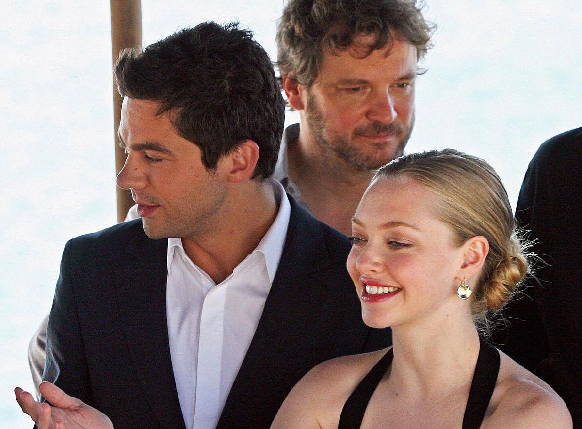 Actress Amanda Seyfried (R) gestures with British actors Dominic Cooper (L) and Colin Firth (C-behind) as they attend a photo opportunity for the promotion of the movie 'Mamma Mia'.