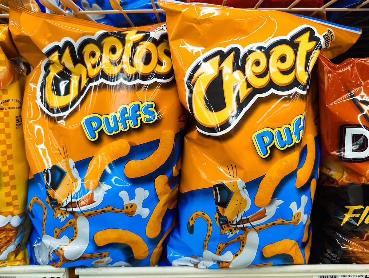 Bags of Cheetos Puffs Cheesy Pizza Cheese Chips Snack Product on Shelf