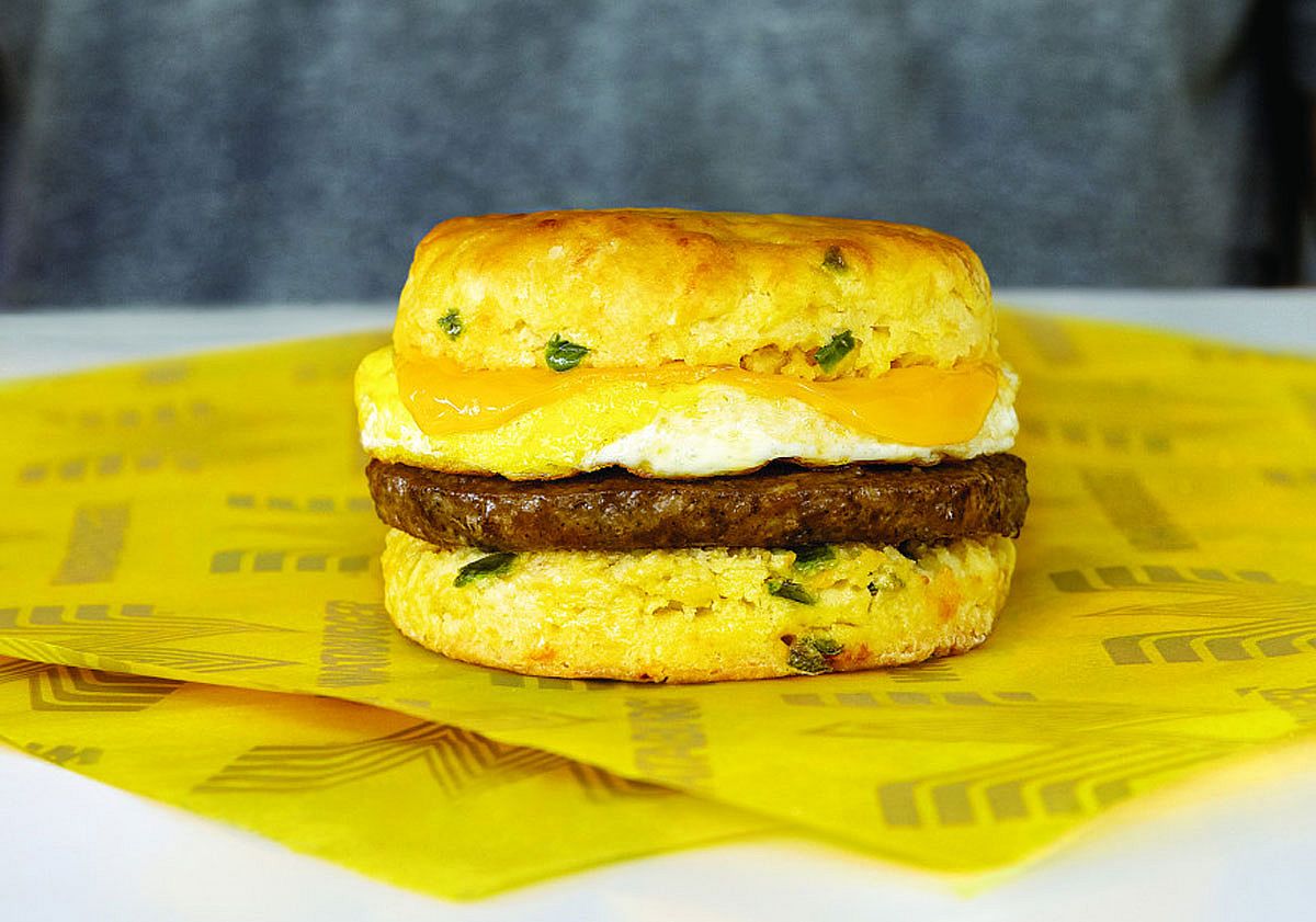 Close shot of a jalapeno cheddar biscuit with sausage from Whataburger sitting on a wrapper
