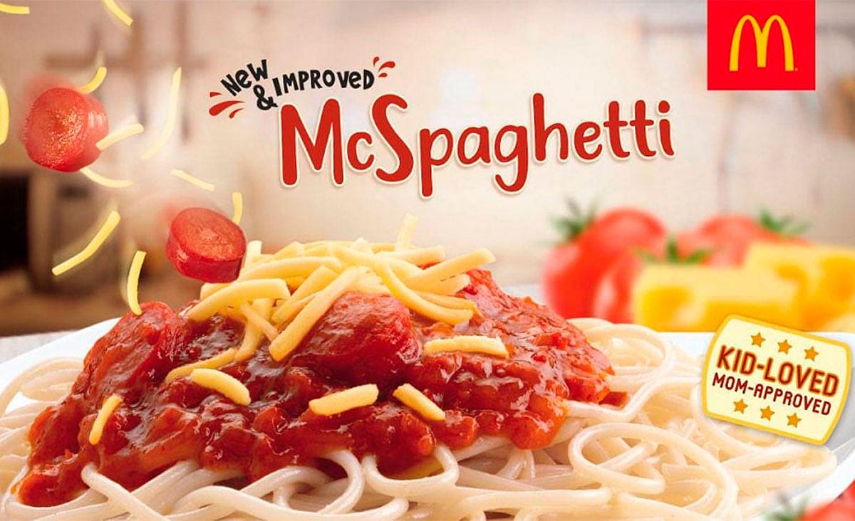 McDonald’s McSpaghetti topped with tomato sauce, sliced hot dogs, and shredded cheese.