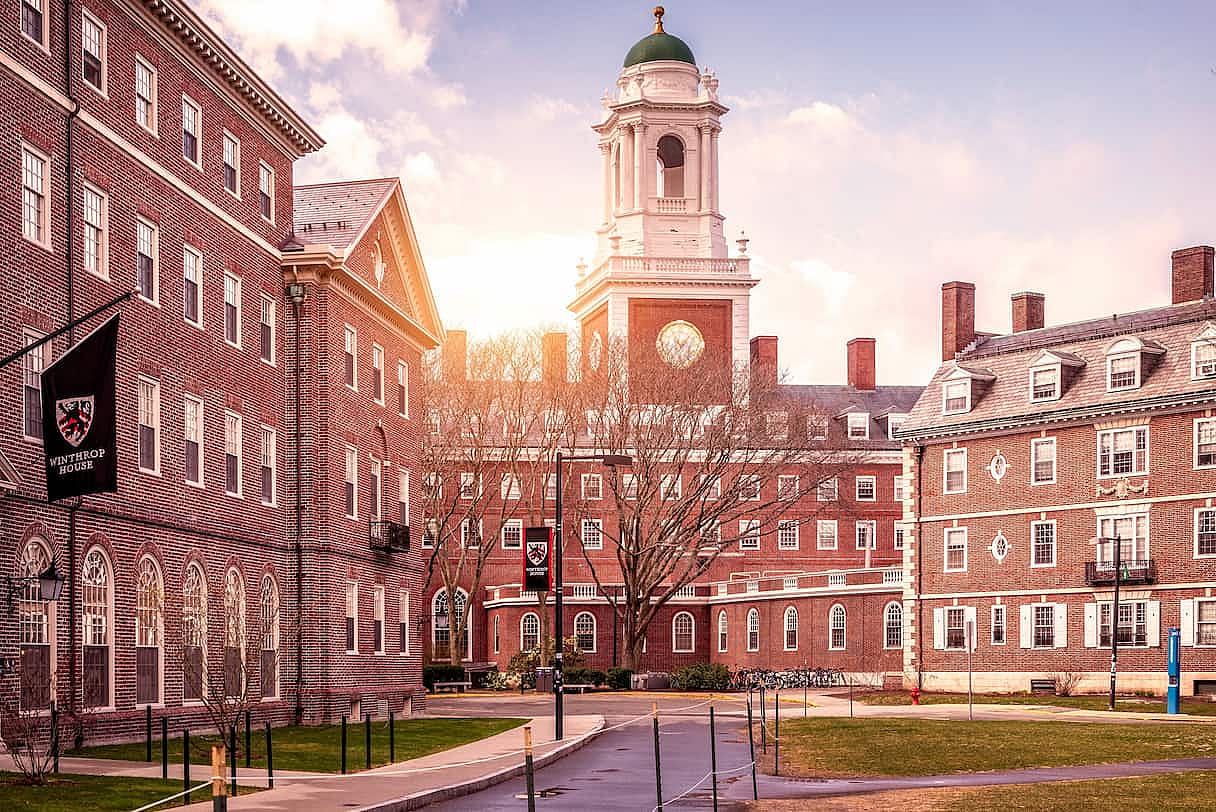 Cambridge, MA, USA - March 15, 2024: View of the architecture of the famous Harvard University in Cambridge, Massachusetts, USA showcasing it brick buildings with some students and locals passing by .