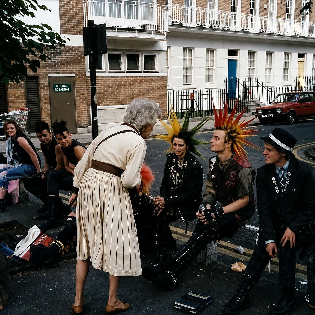 An old lady talking to punks in 1982