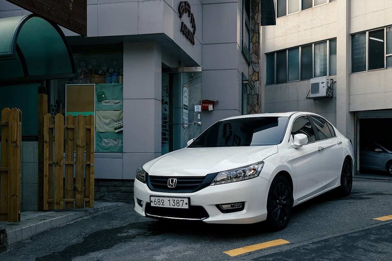 White Honda Accord, the ninth-generation Accord, a mid-size car introduced in 2012, parked in building area in Seoul. vehicle registration plate of South Korea.