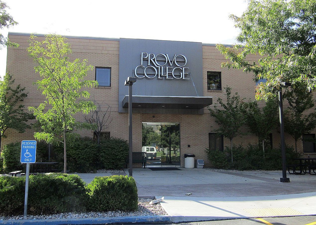 A brick building with a metal sign on top.