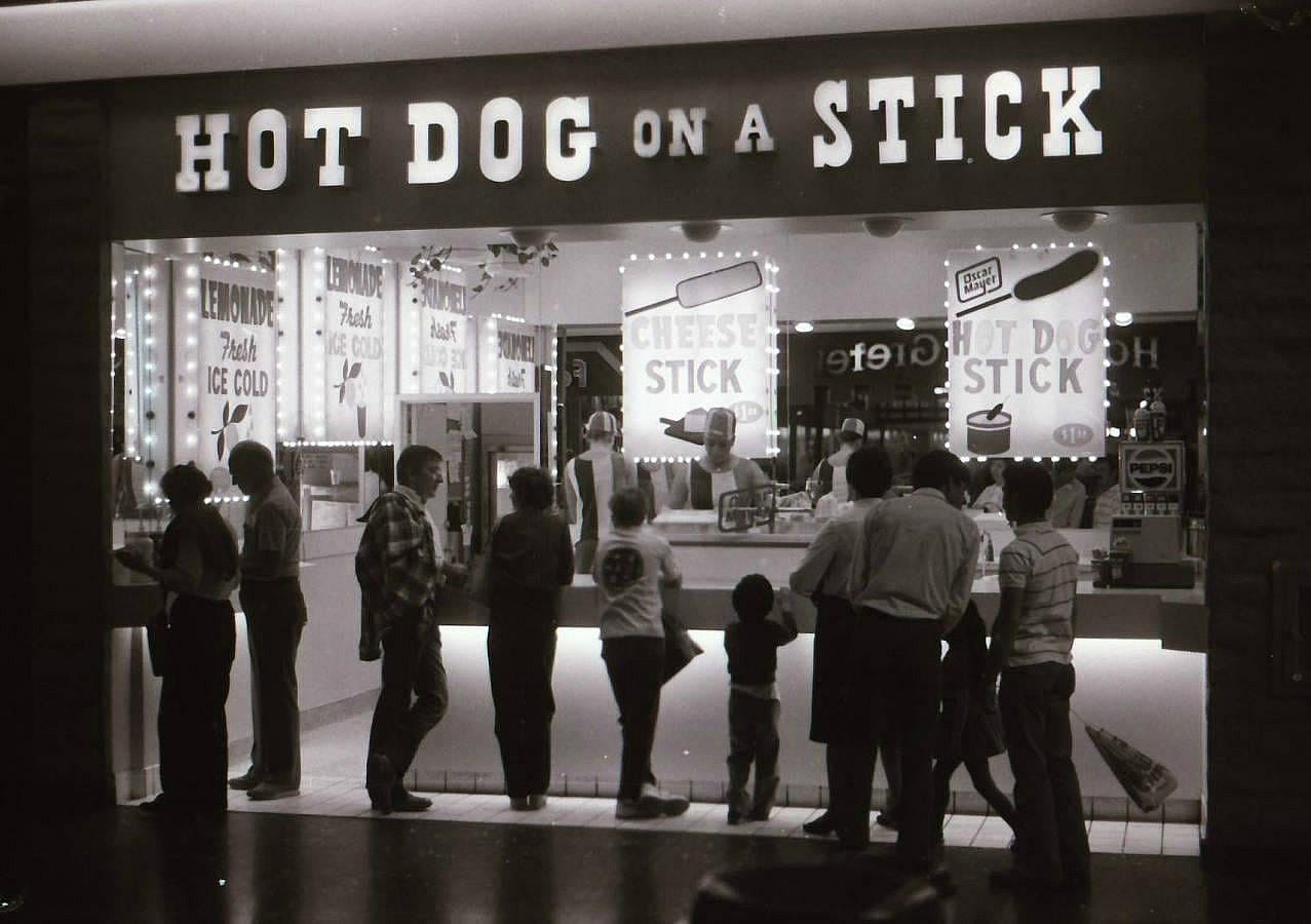 People waiting for their hot dog on a stick