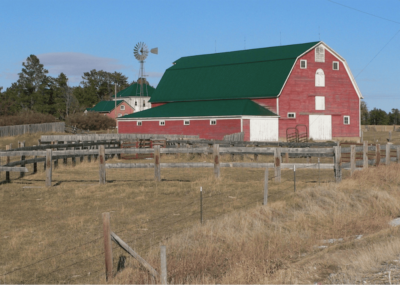 A classic red barn with a green roof