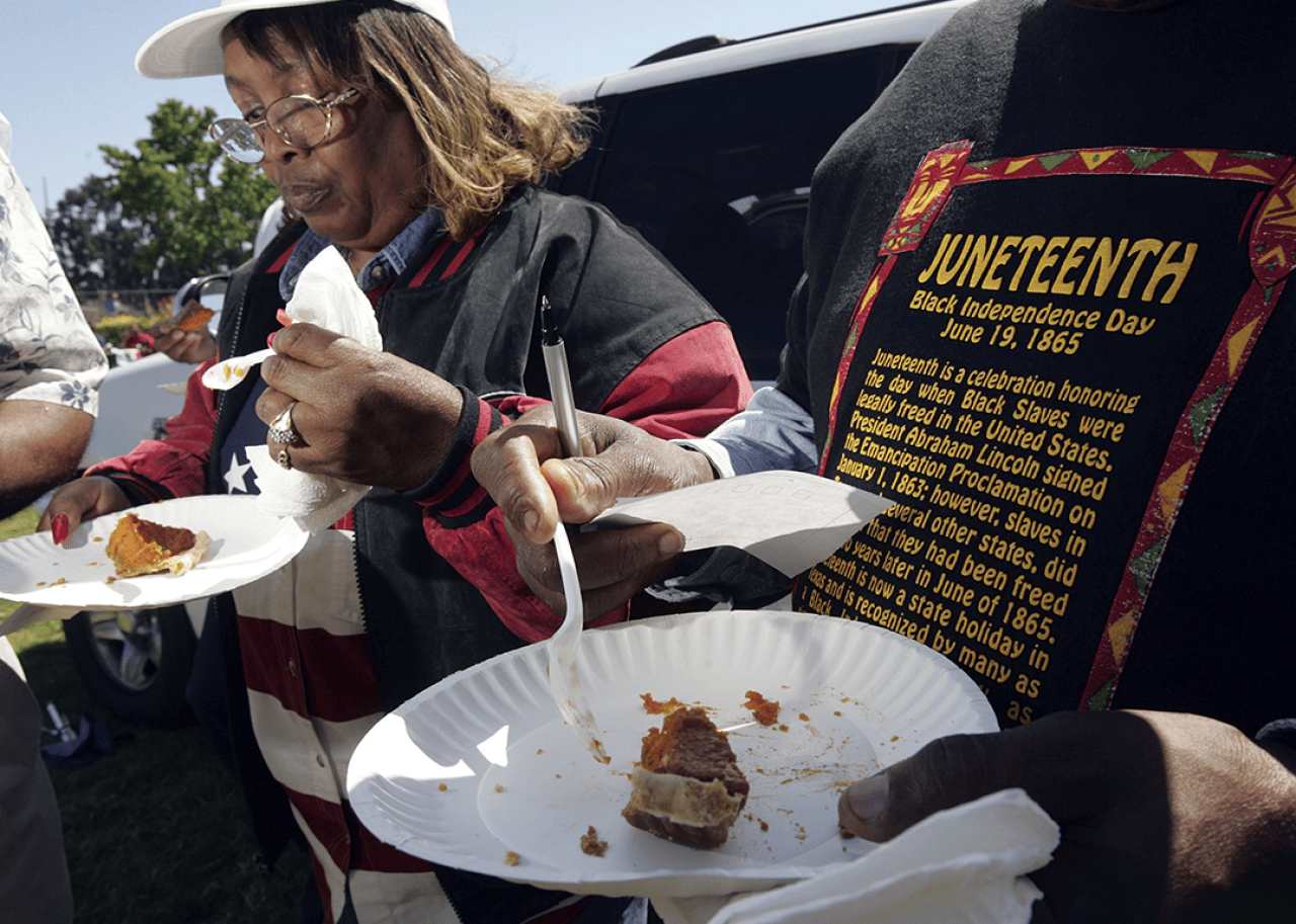 People take part in a cook-off contest at Juneteenth.