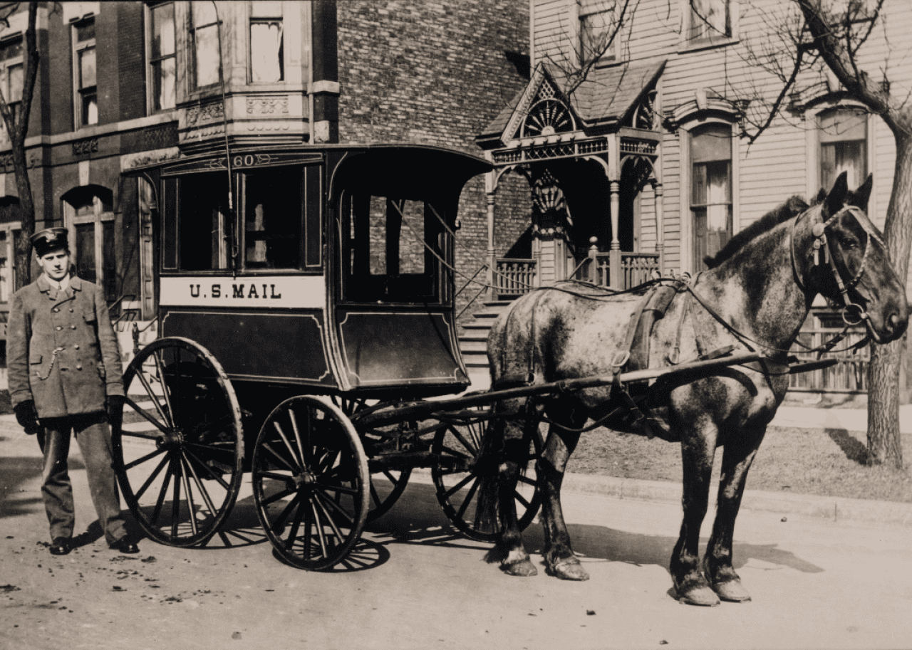 Postman delivers mail by horsedrawn carriage